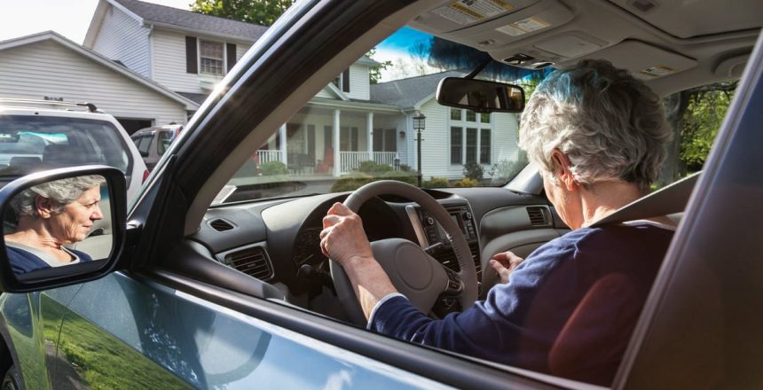 person_driving_car_in_front_of_house_d80LfSE