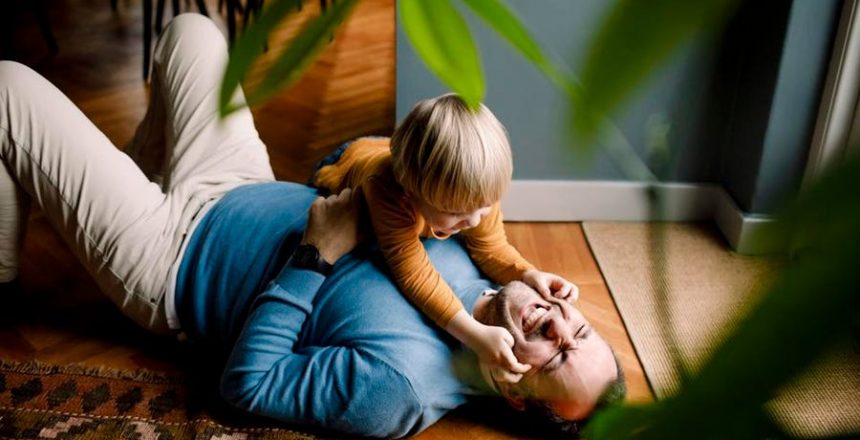 playful-son-playing-on-floor-with-father.jpeg